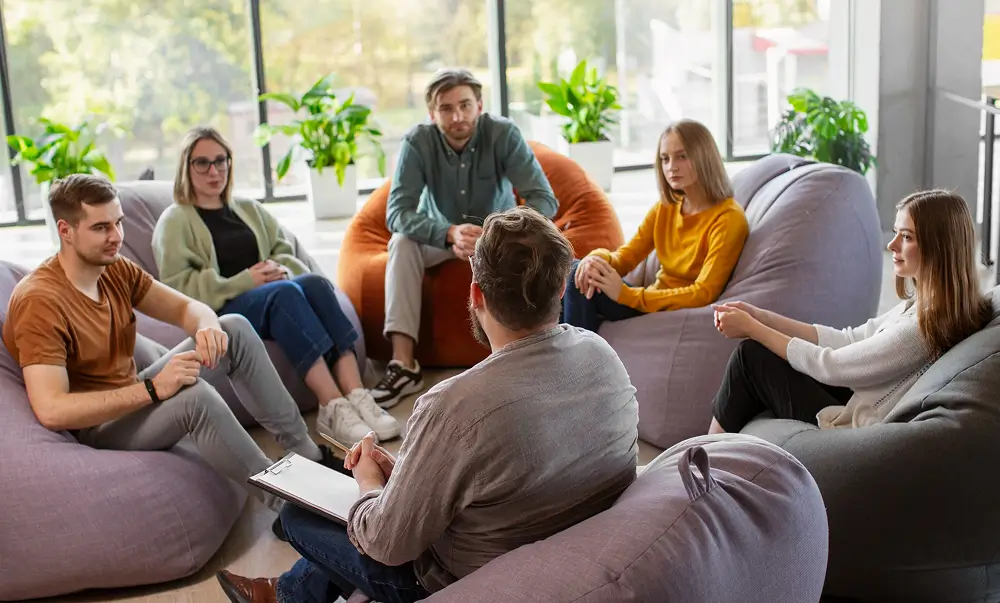 Group therapy session in a relaxed lounge setting