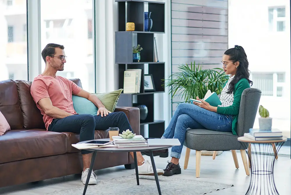 Therapist and client talking in a modern living room