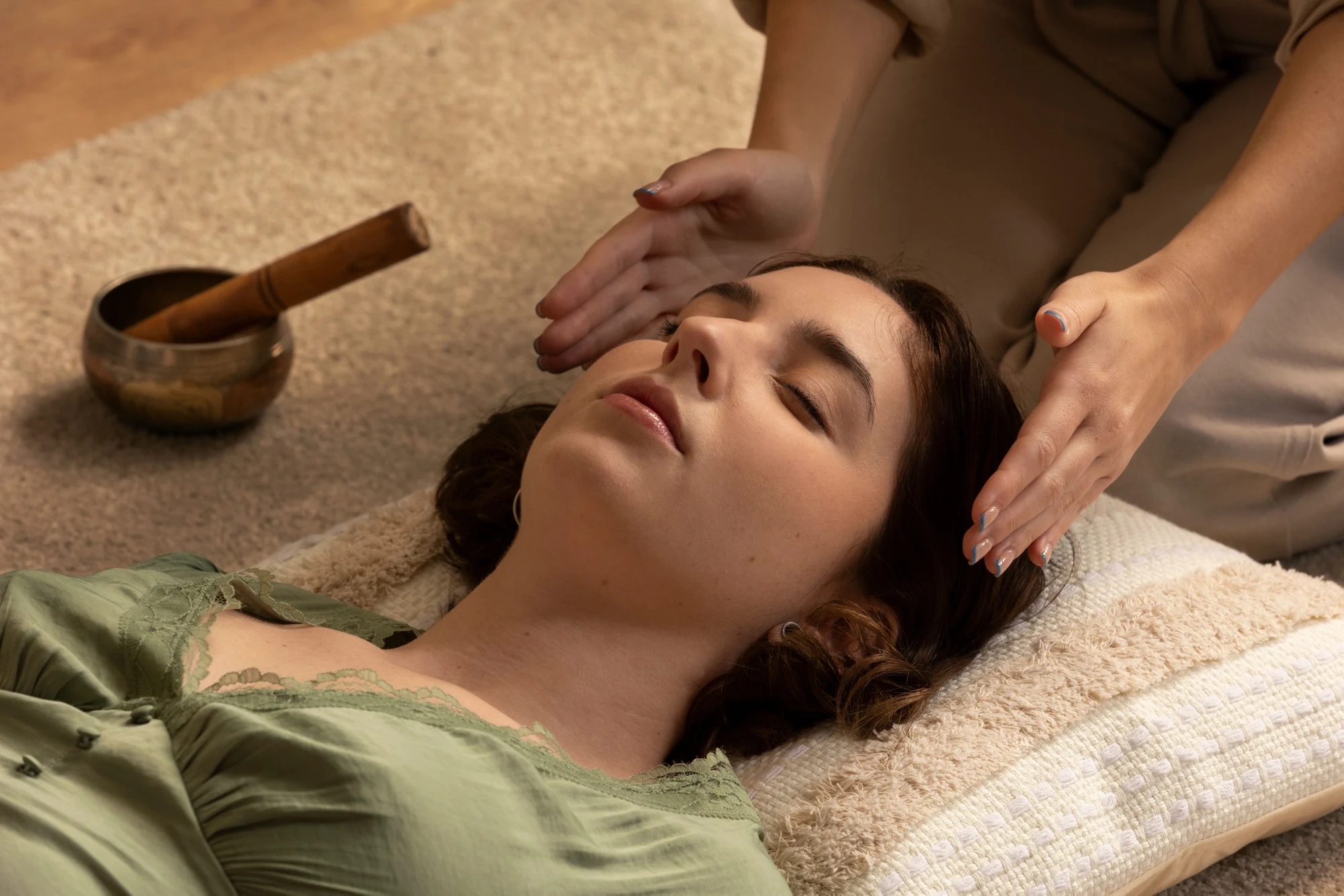 Woman receiving a relaxing head massage during holistic therapy