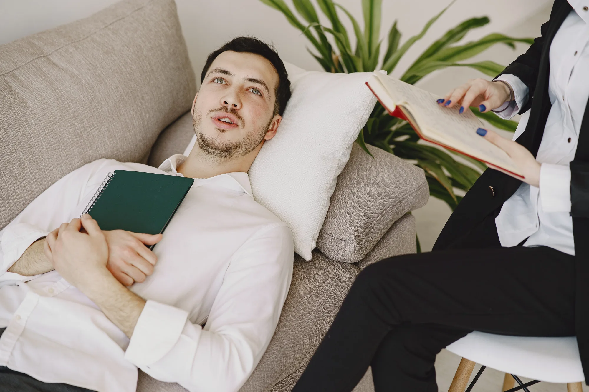 Man lying on a couch talking with a therapist
