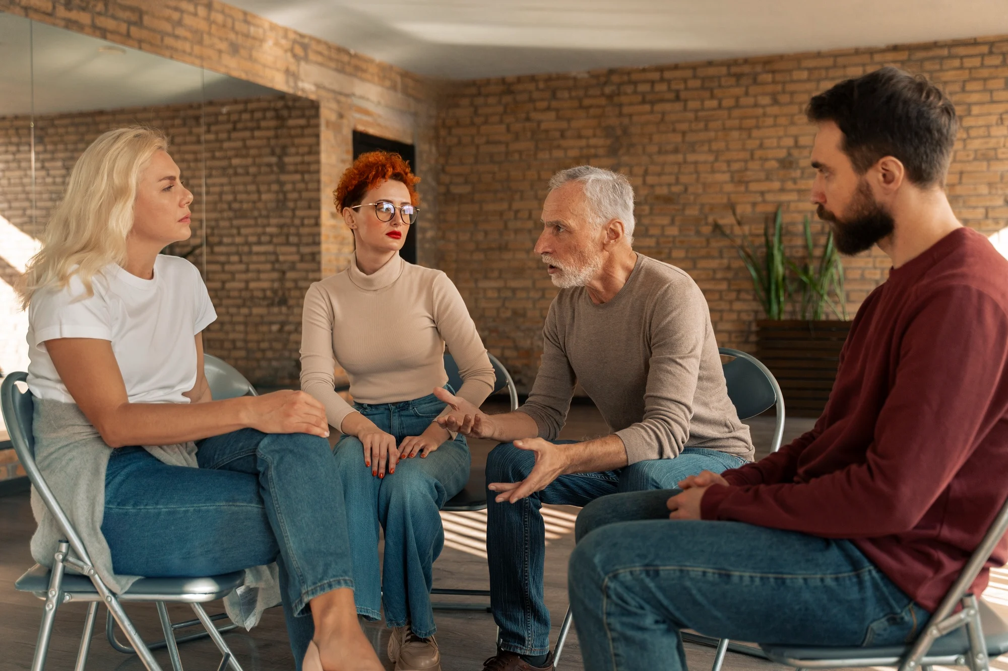 Adults talking together in a group therapy circle