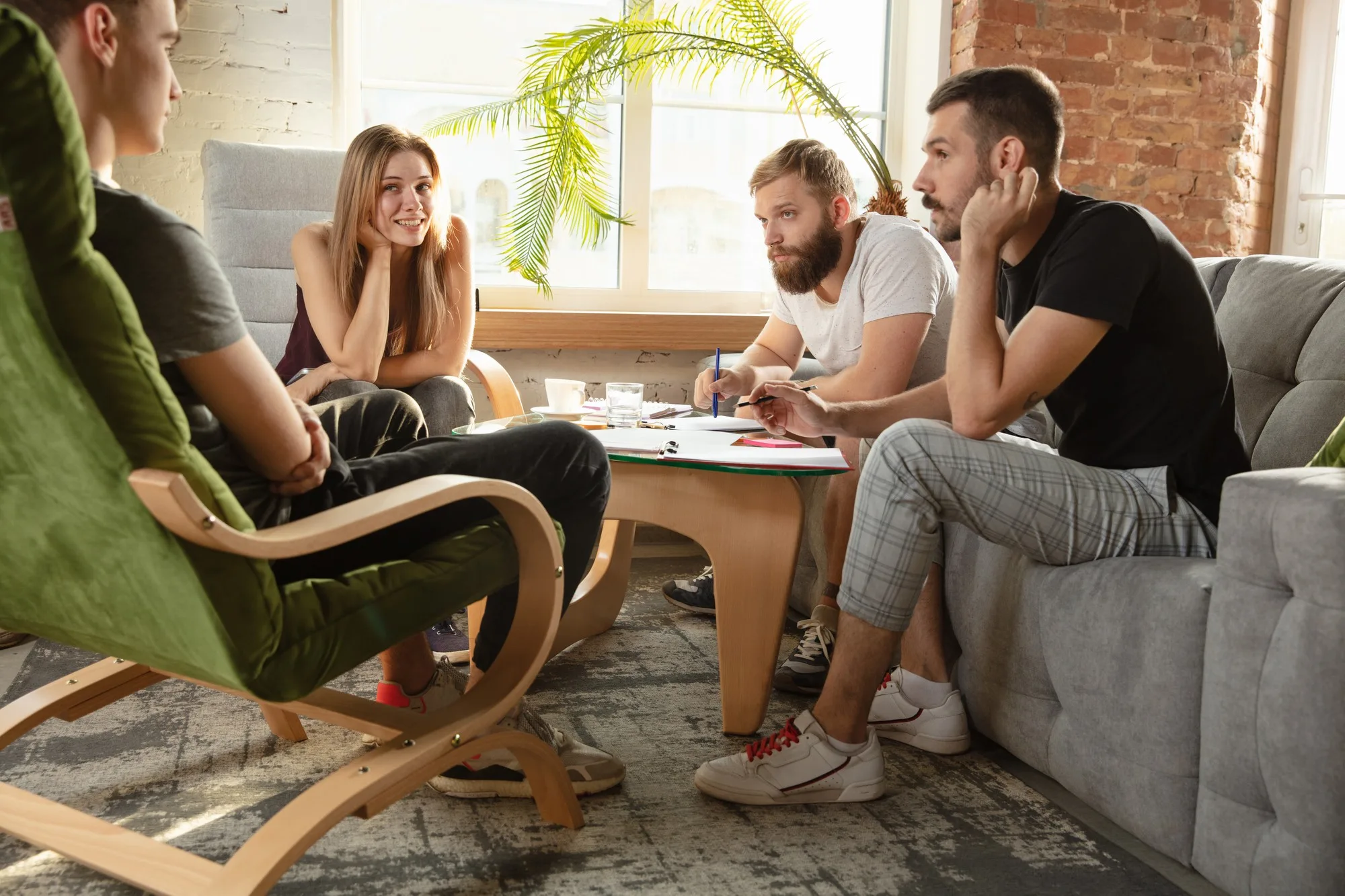 Clients talking with a counselor in a comfortable living room