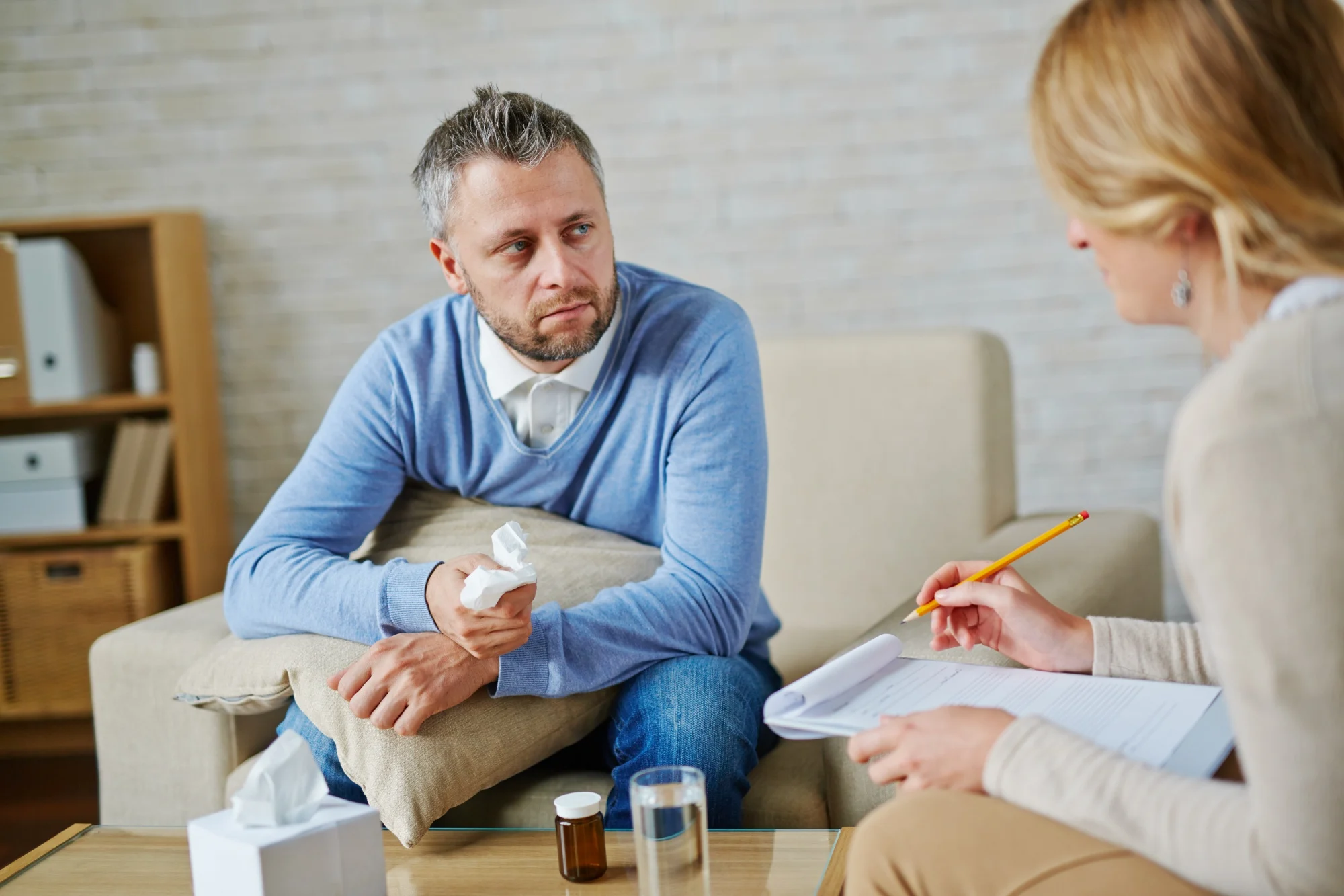 Man talking with a counselor who is taking notes