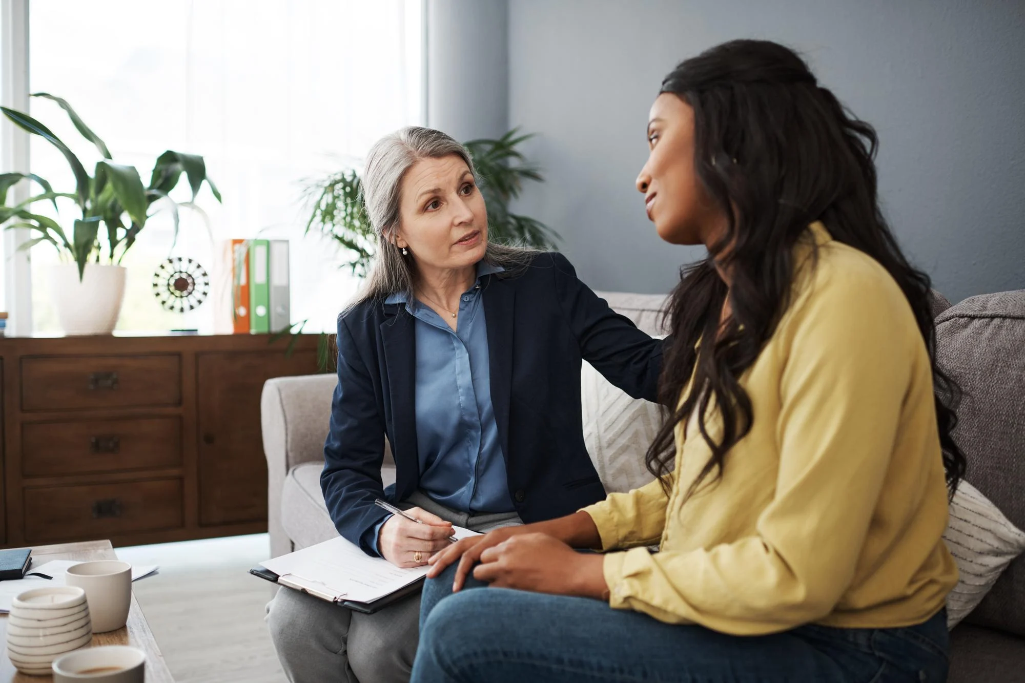 Counselor comforting a woman during a one-on-one session