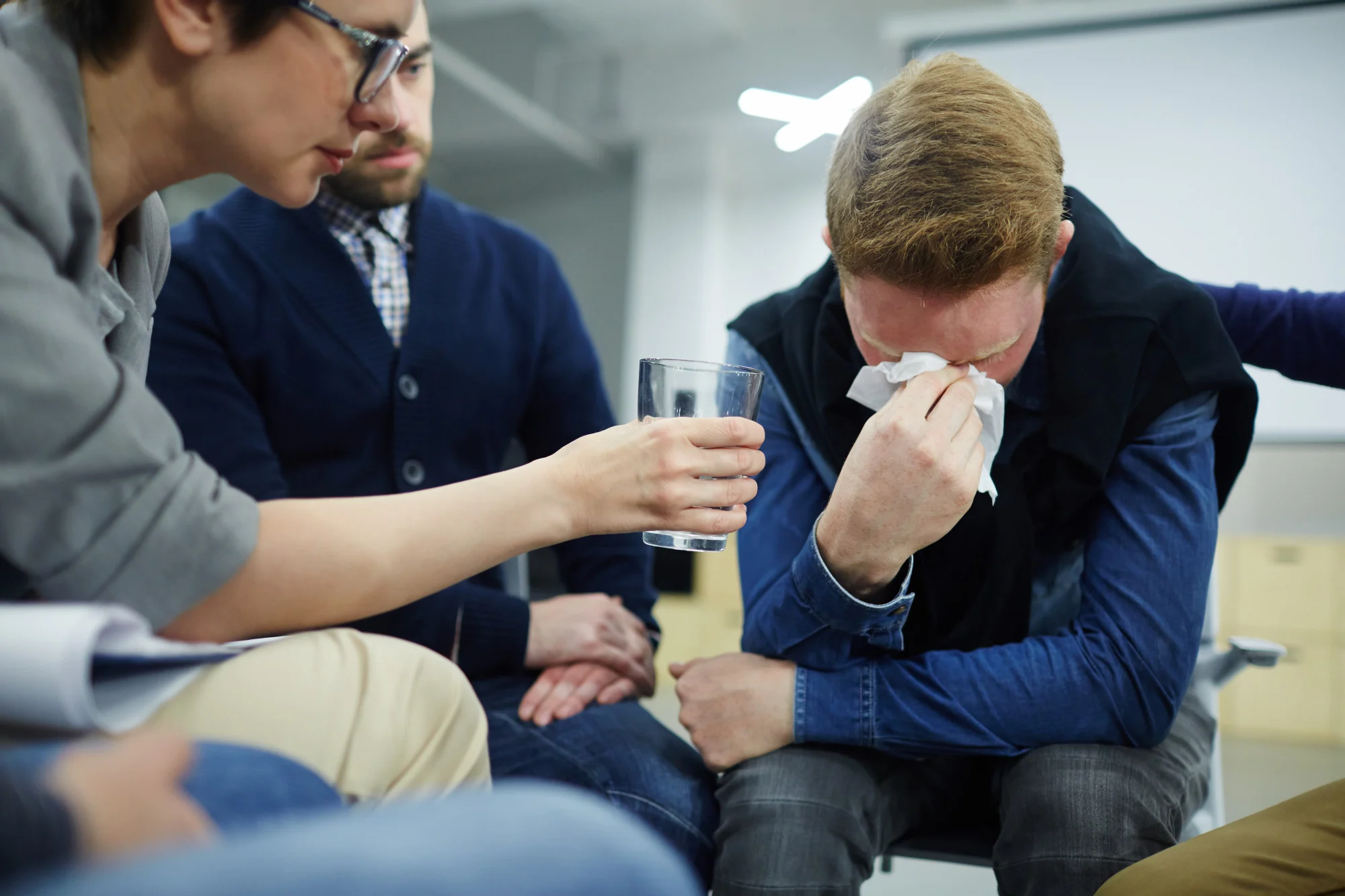 Man overcome with emotion during a support group session